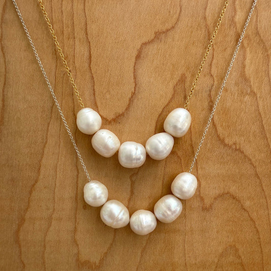Pearl necklace on a wooden surface