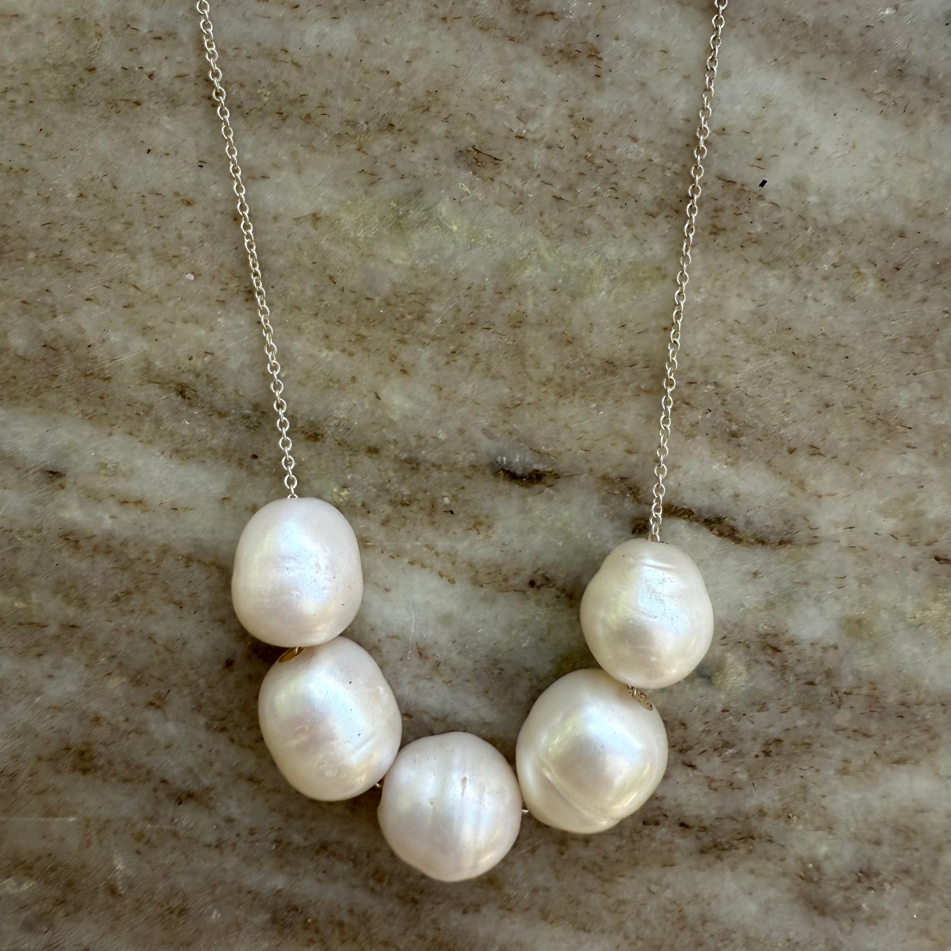 Pearl necklace on a marble surface