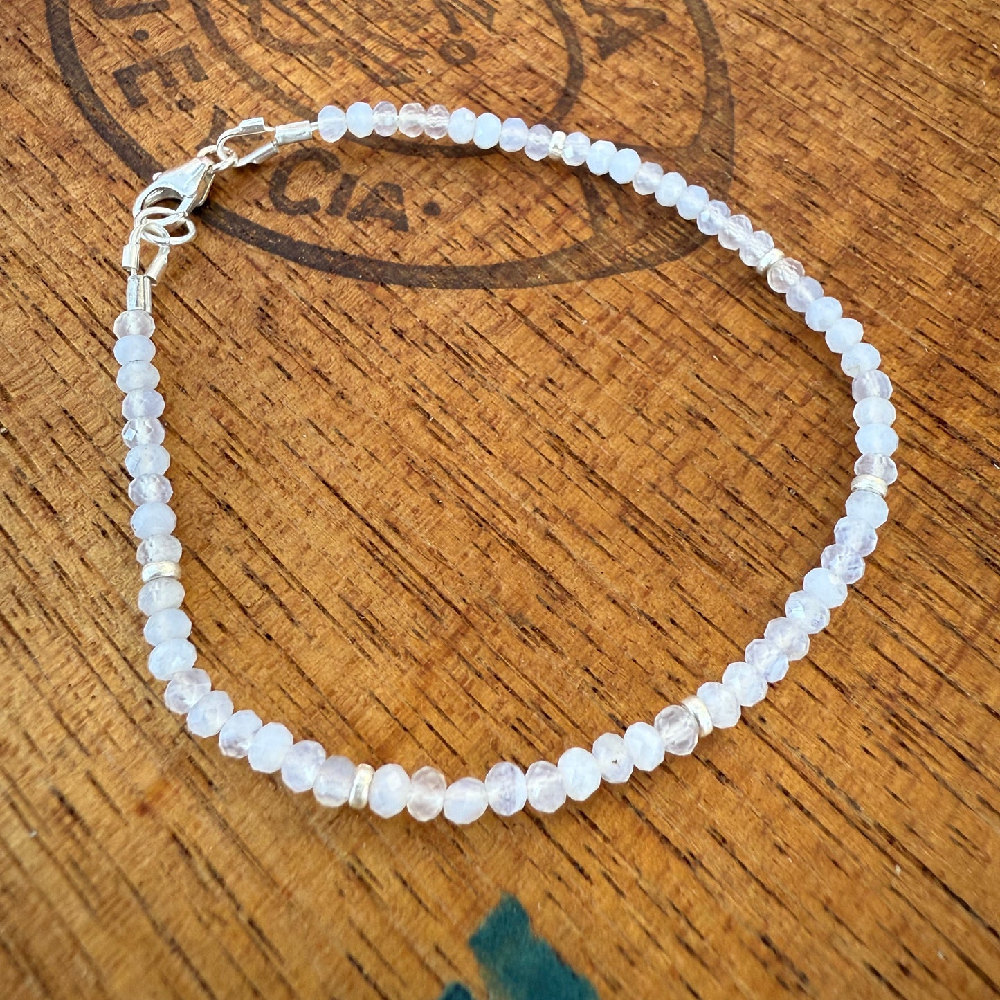 White beaded bracelet on a wooden surface