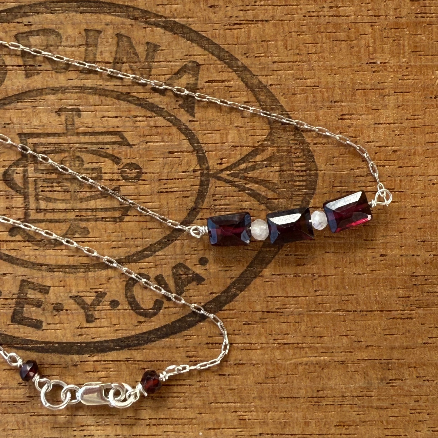 Three garnet baguettes on sterling silver chain