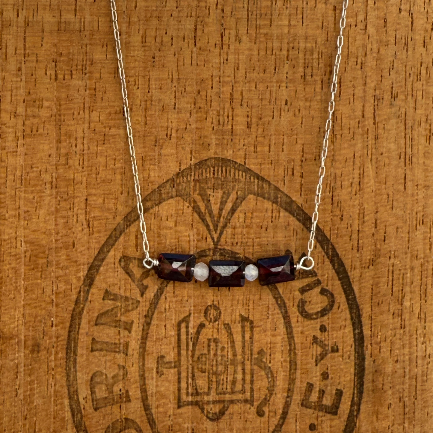 Three garnet baguettes on sterling silver chain