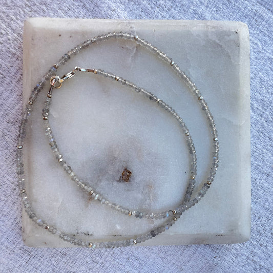 Beaded labradorite necklace on a marble surface