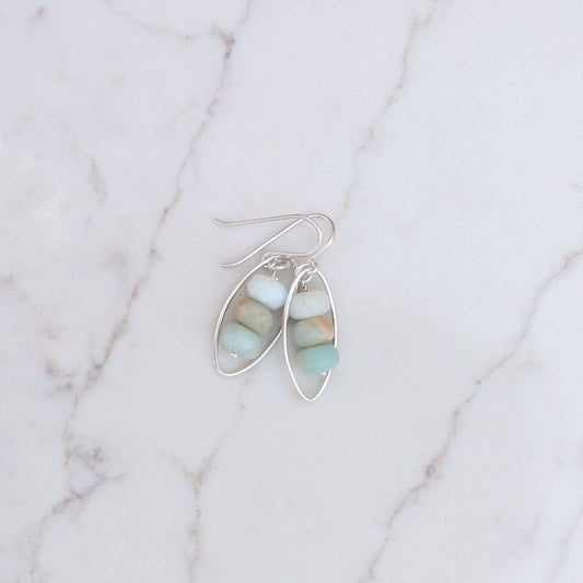 Stack of Amazonite Beads in Silver on marble surface